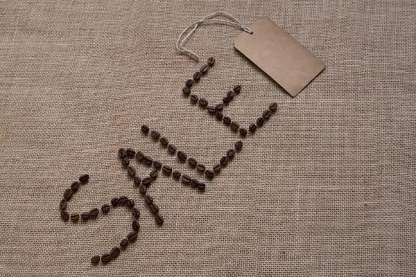Word sale from coffee beans on burlap