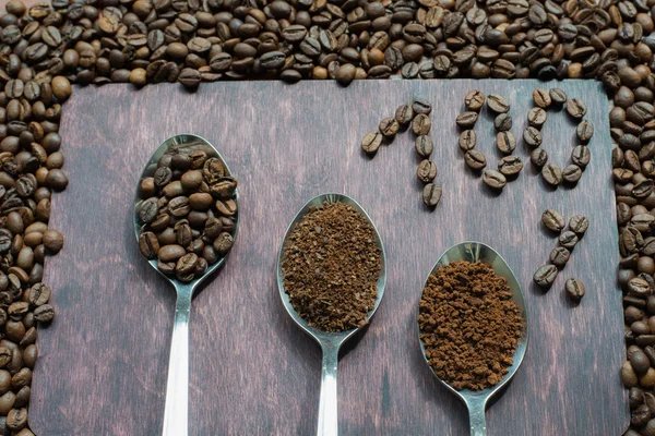 Three stages of spoons in coffee - beans, ground, instant