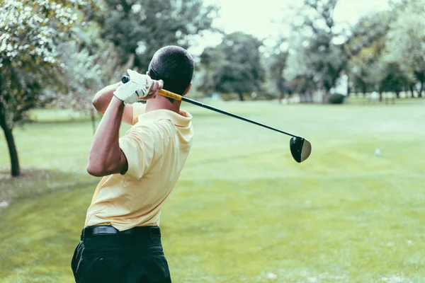 Golfer finishing his driver swing