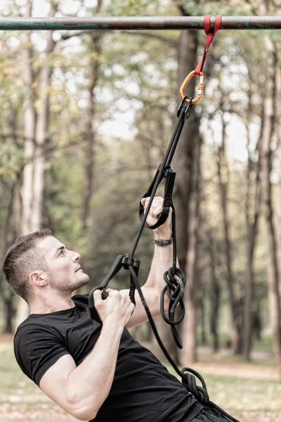 Man exercising with fitness straps