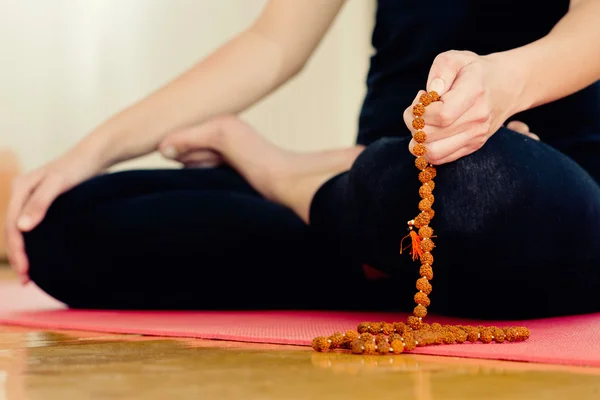 Woman Meditating with rosary beads