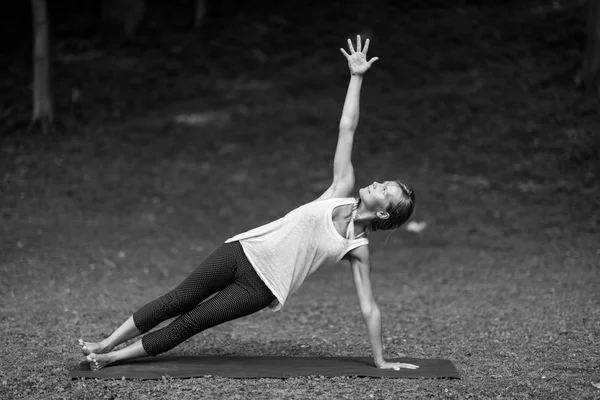 Girl doing Side plank pose