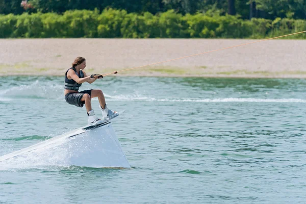 Wakeboarder jumping  on platform