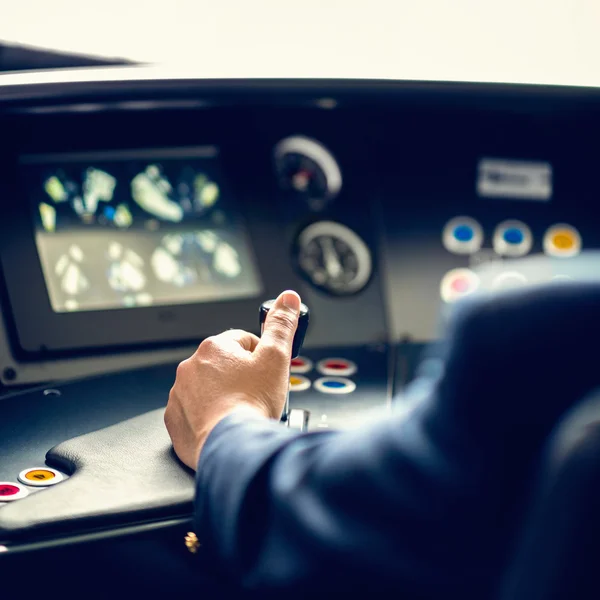 Train driver in control cabin