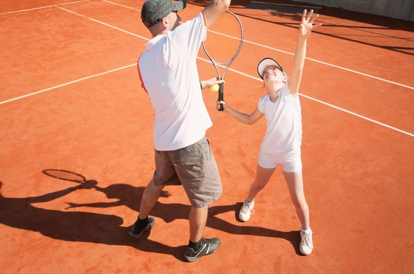 Tennis instructor with Junior player