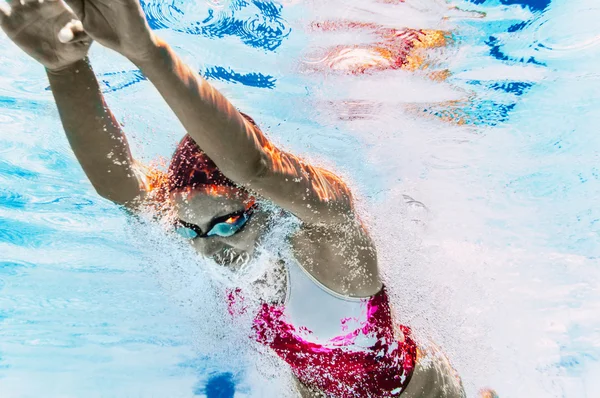 Woman dives into swimming pool