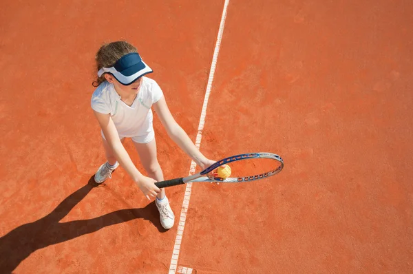 Tennis player preparing to serve