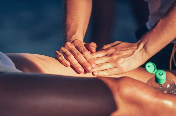 Sport therapist massaging leg