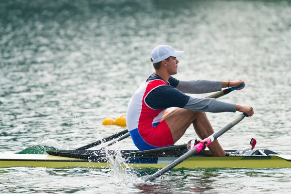 Athlete rowing single scull