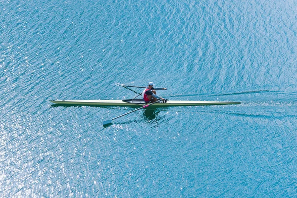Athlete rowing single scull