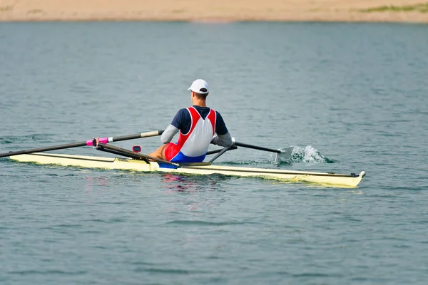 Athlete rowing single scull