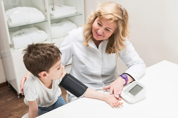 Little boy measuring blood pressure