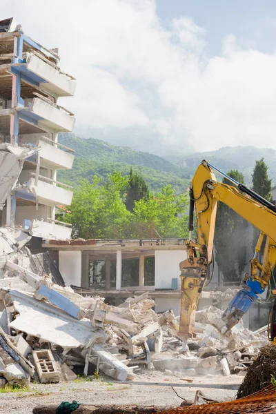 Construction machines demolishing building