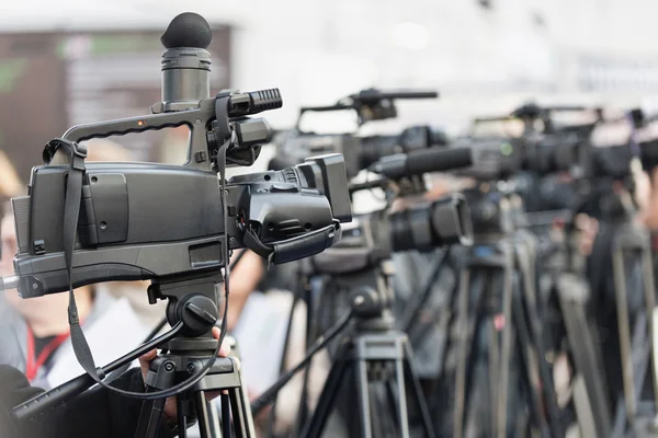 Row of tv cameras at event