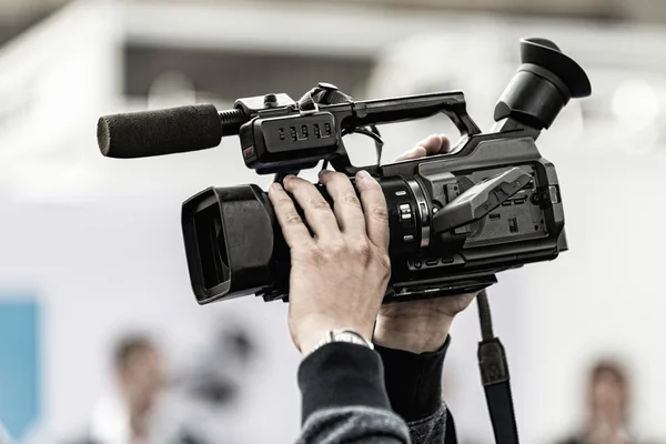 Cameraman holding tv camera