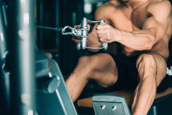 Man exercising on rowing machine