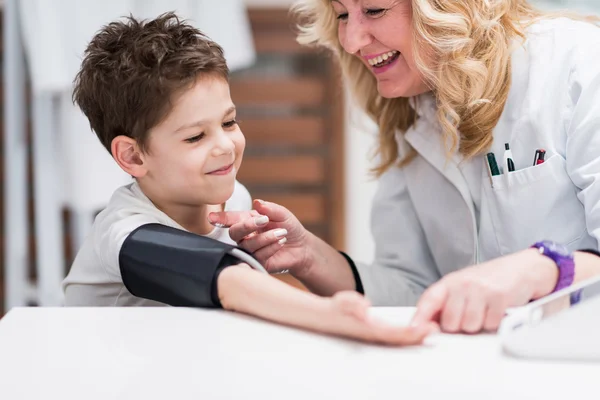 Little boy measuring blood pressure