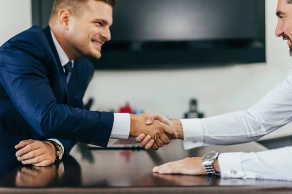 Business people reaching agreement, shaking hands