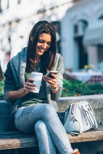 Beautiful girl with coffee and phone