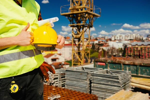 Construction worker on site gesturing thumbs up