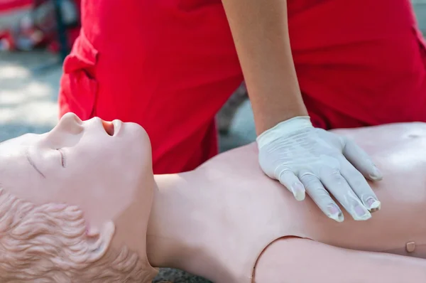 Paramedic woman practicing chest compression