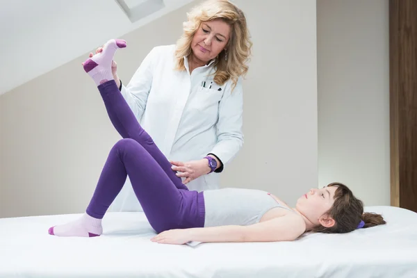 Physical therapist working with child