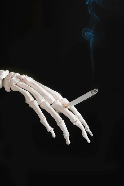 Skeleton hand with cigarette