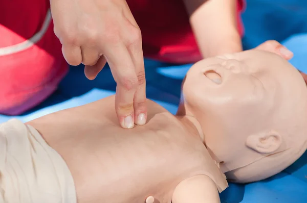 Woman doing infant chest compressions