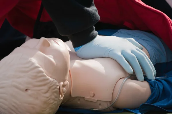 Paramedic woman practicing chest compression