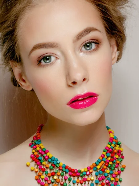 Fashion studio portrait of beautiful young woman with elegant hairstyle