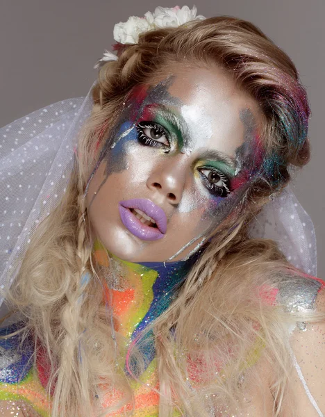 Creative make up with splashes of color. Body ert
