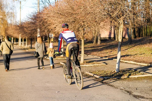 Man on bike in sportswear in the city park.
