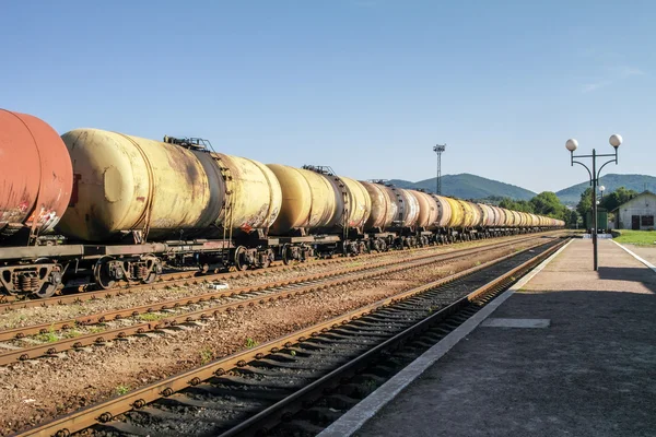 Freight trains.Railroad train of tanker cars transporting crude oil on the tracks.