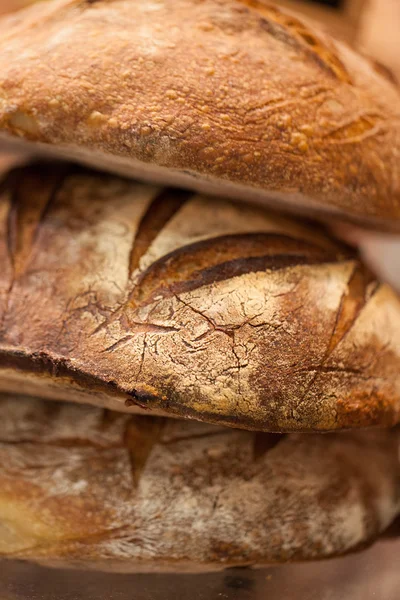 Macro of crusty wholewheat French baguettes at traditional bakery shop