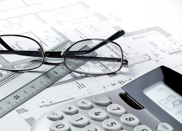 Property design and cost concept with eyeglasses and calculator