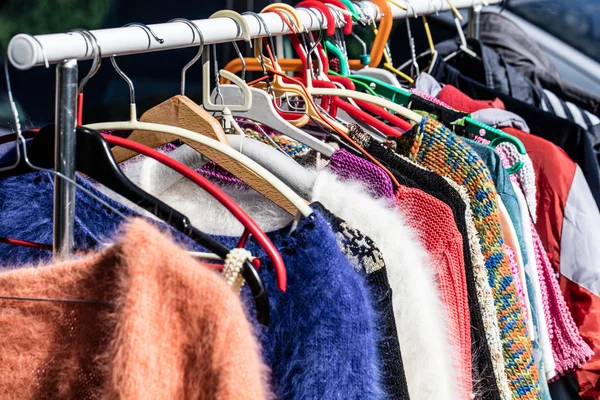 Colored second hand women\'s sweaters at flea market