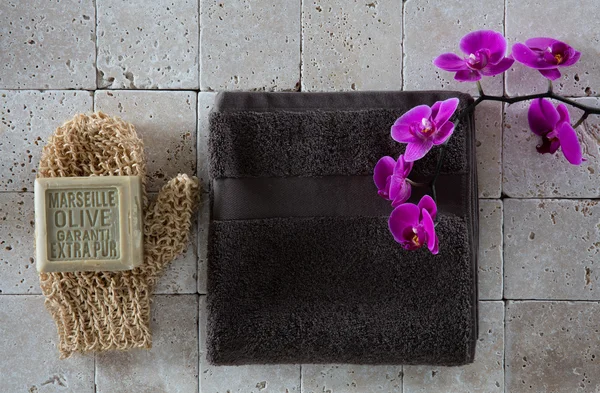 Exfoliating concept with mitt, olive oil soap and cotton towel