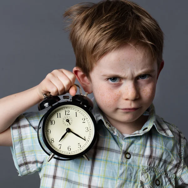 Displeased young kid reproaching someone to be late, time concept