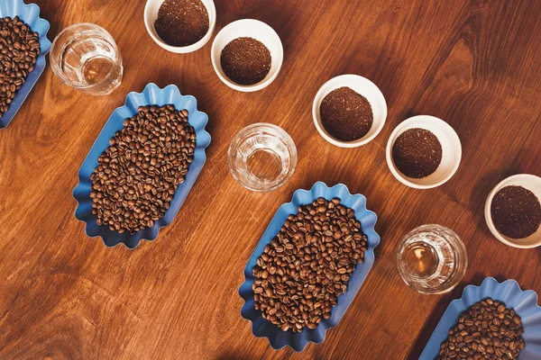 Coffee cups and beans on table for tasting