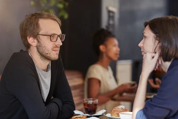 Man having meeting in busy cafe