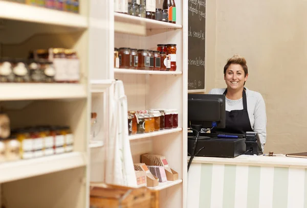 Deli worker standing behind counter