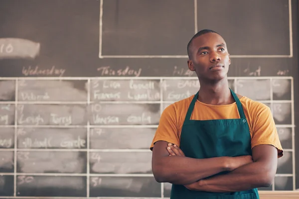 Craftsman standing with arms folded