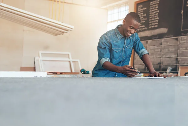 Designer working on plans at studio table