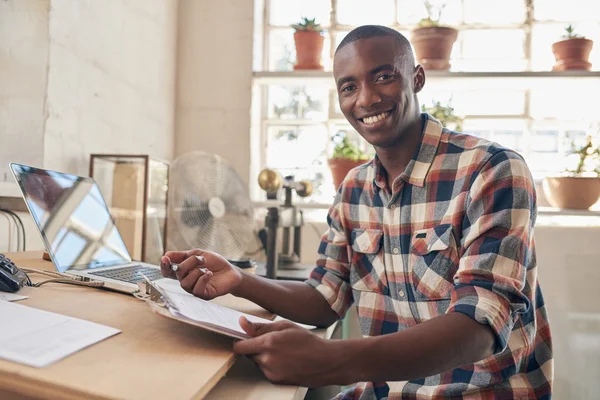 Entrepreneur holding paperwork at desktop