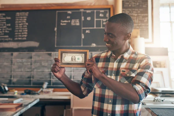 Business owner showing dollar bill