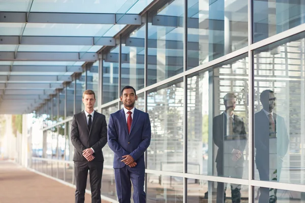 Businessmen standing in front of office building