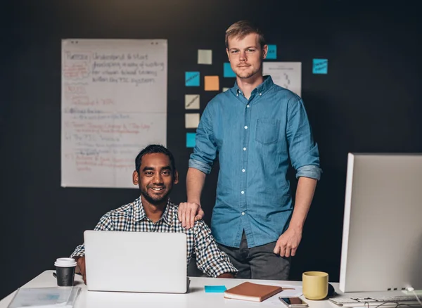 Entrepreneur standing with hand on shoulder of colleague