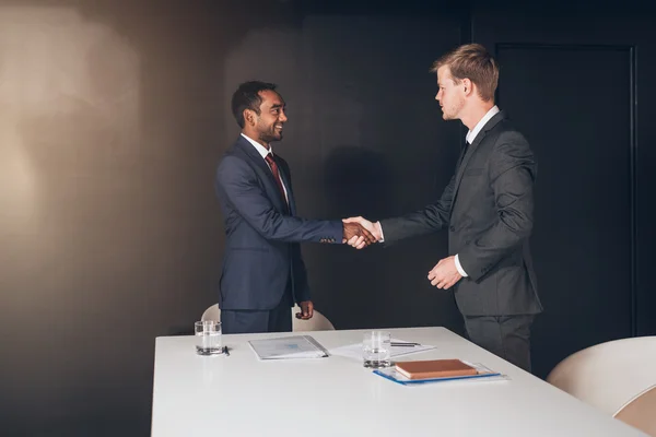 Businessmen shaking hands after successful negotiation