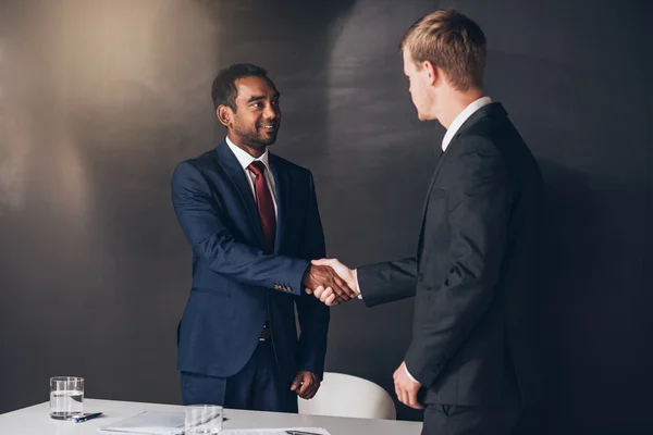 Businessmen shaking hands after successful negotiation