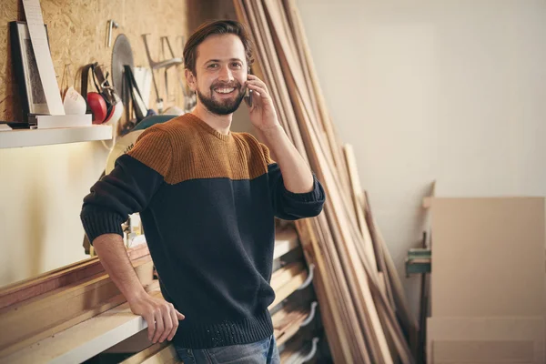 Man talking on phone in workshop